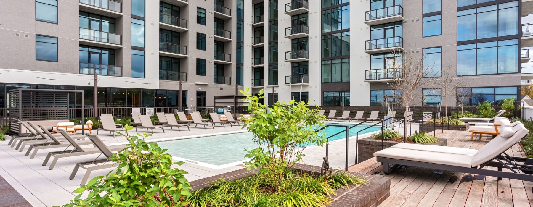 Resort-style swimming pool with lounge seating