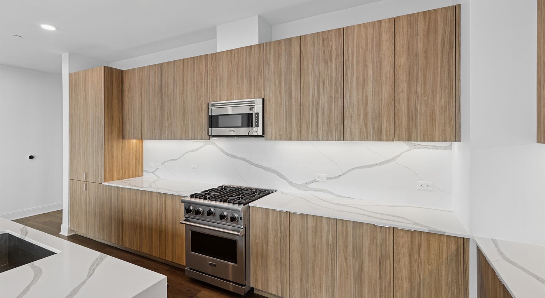 a kitchen with a marble backsplash