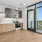 kitchen with wood cabinets by a glass wall and balcony