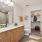 brightly lit bathroom with walk-in closet