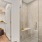 walk-in shower with glass door and walk-in closet in bathroom