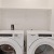 side-by-side washer and dryer in bright laundry room